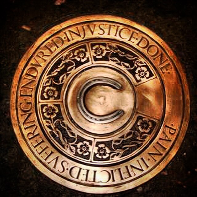 The bronze horseshoe memorial to the Paisley witches at Maxwellton Cross
